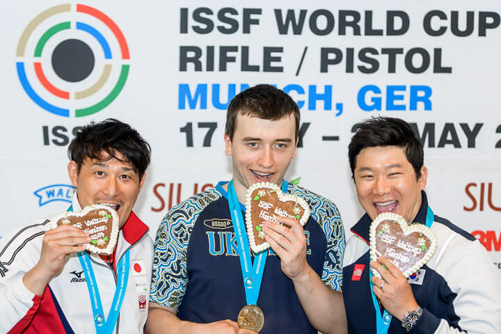 From Left - Tomoyuki Matsuda, Pavlo Korostylov & Jin Jongoh pose with their medals. Photo: ISSF