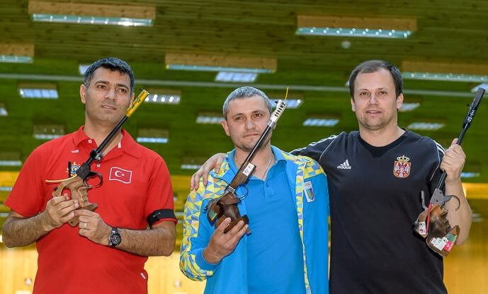 (From Left) Yusuf Dikec, Oleh Omelchuk and Damir Mikec pose after the Men's 50m Pistol finals. Photo - ISSF