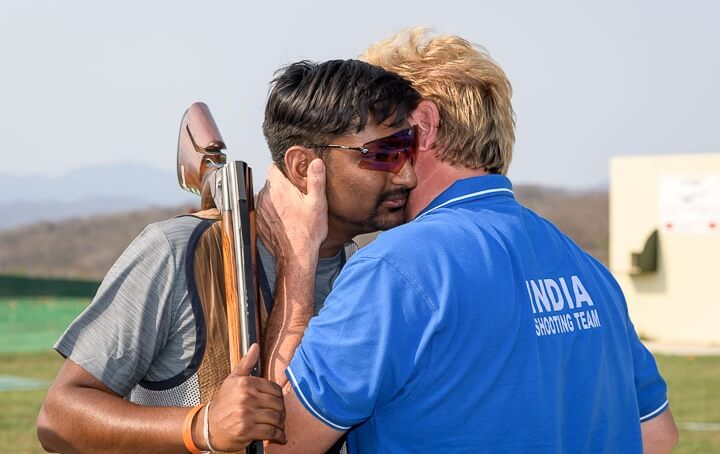 Ankur Mittal congratulated by coach Marcello Dradi. Photo - ISSF